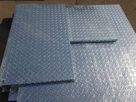 Some compound steel gratings with different sizes placed on the ground.