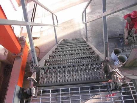 A diamond-strut safety grating is used as stair tread.