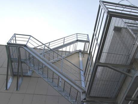 The welded steel grating stairs setting in the exterior of the building.