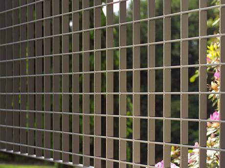 Welded steel grating infill panels are used as fences of garden.