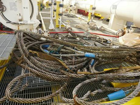 Some of the ropes are cluttered on a serrated steel grating drilling platform.