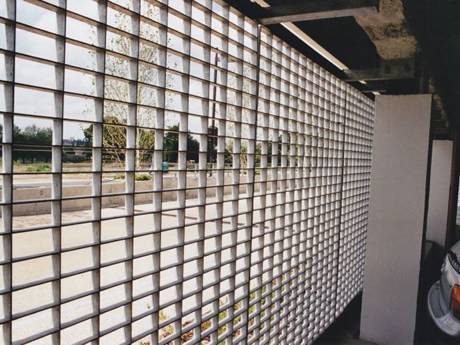 Steel grating infill panels are used as fences of the parking garage.