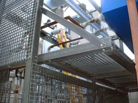 This is a machine with steel grating partition panels to protect it.