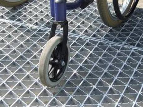 A small bicycle is passing riveted grating walkway.