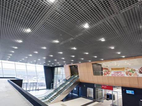 It is steel grating ceiling picture of airport waiting room.