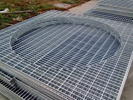 There are hollow round steel gratings on  the ground.