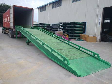 The mobile galvanized ramp connects with the container.