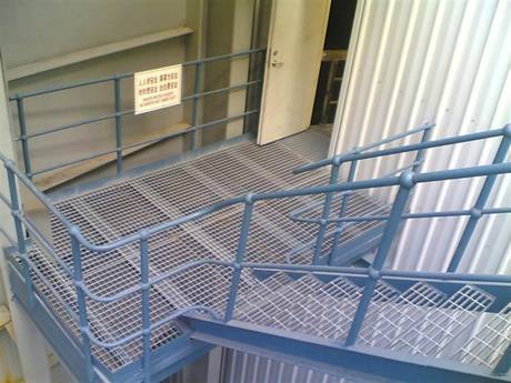 This is a part of the factory that is consisted of steel grating stair and steel grating floor.