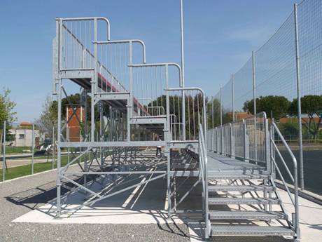 This is a stands with steel grating stairs in the playground.