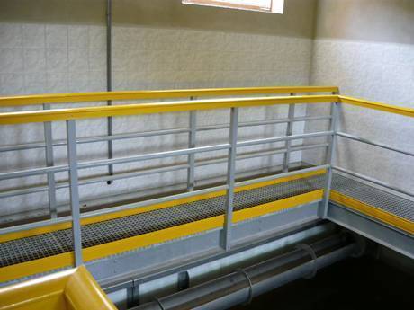 This is a corner of the factory with steel grating walkway.