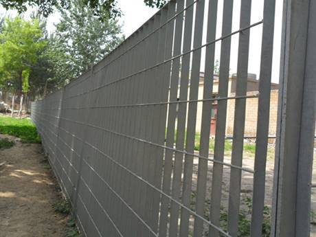 This land is divided into two areas by welded steel grating fence.